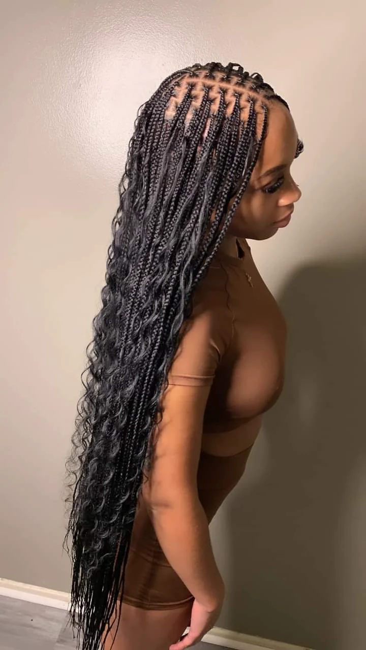 Extra-long boho knotless braids with curly accents created by Elegant African Braiding