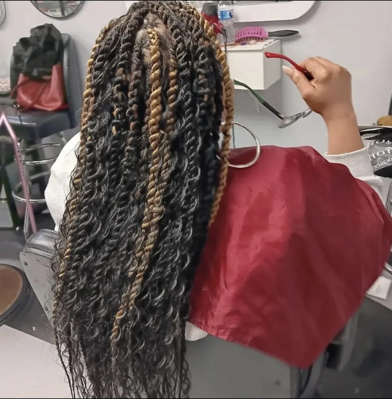 Island twists with curly texture and dimensional color by Elegant African Braiding