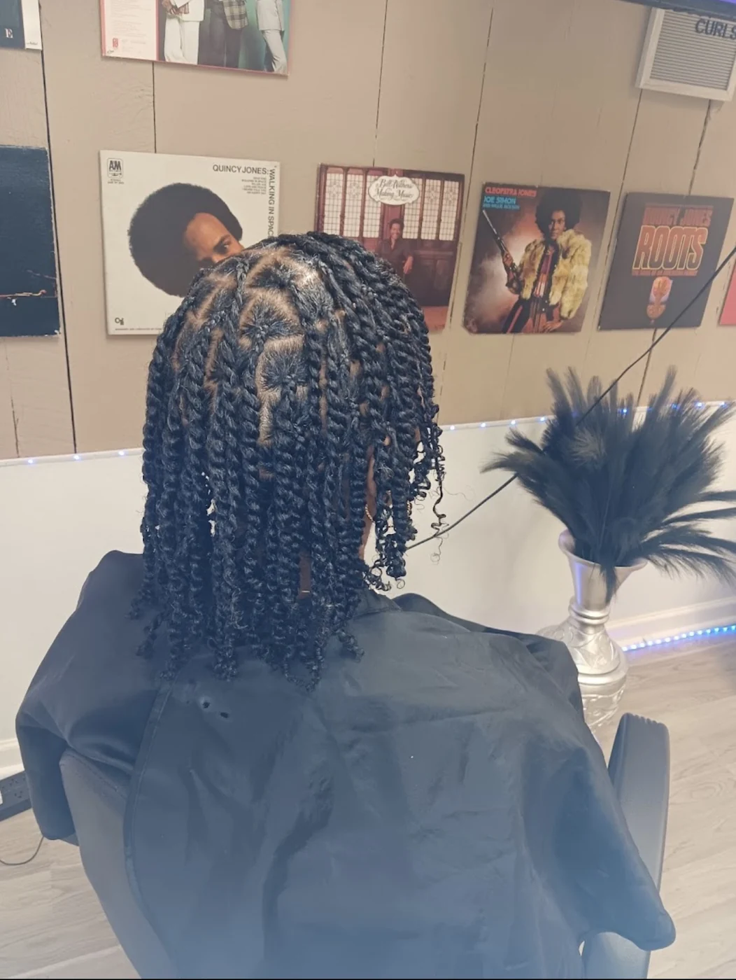 Protective twists created by Elegant African Braiding with clean geometric parting and shoulder-length finish